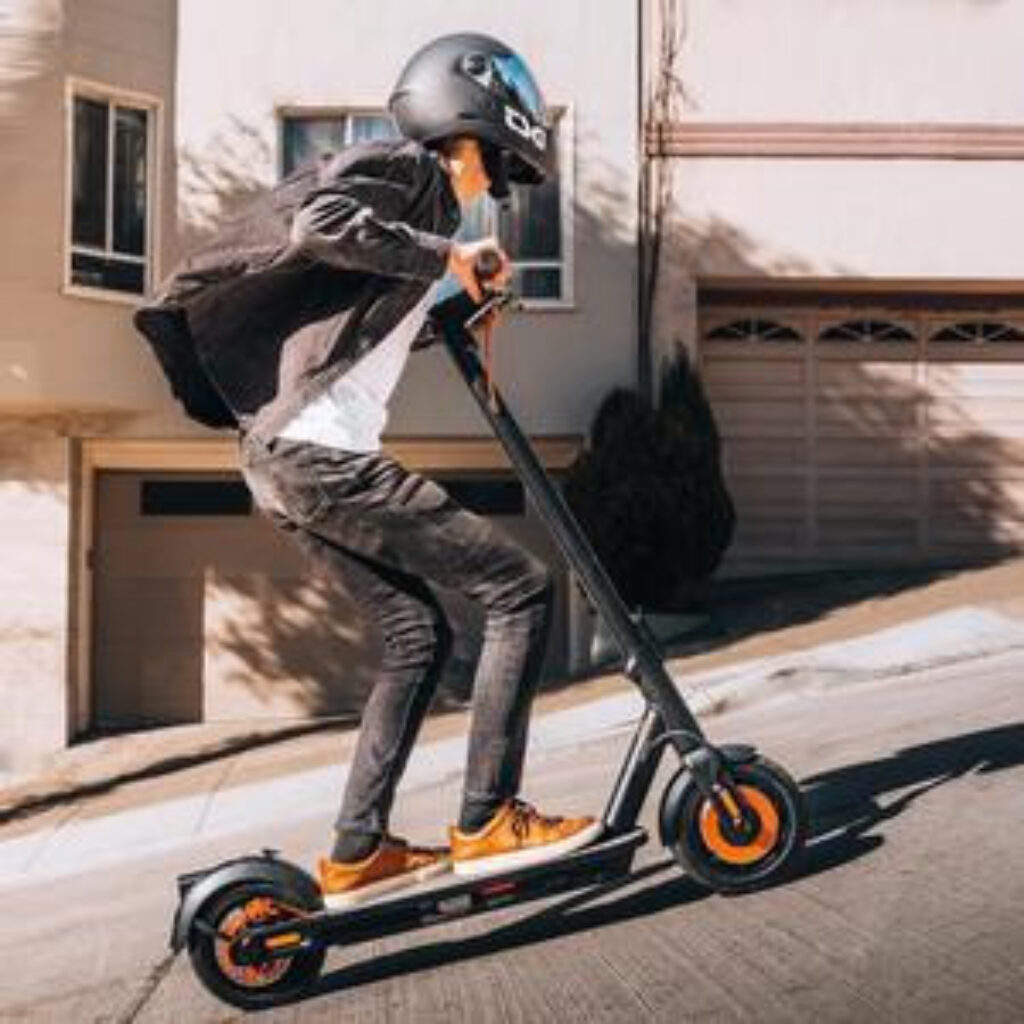 Rider going up a steep hill on their segway ninebot e-scooter